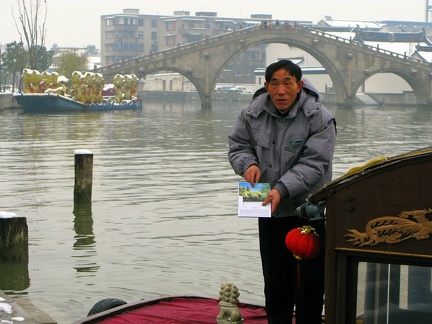 He is selling either boat rides or post cards
